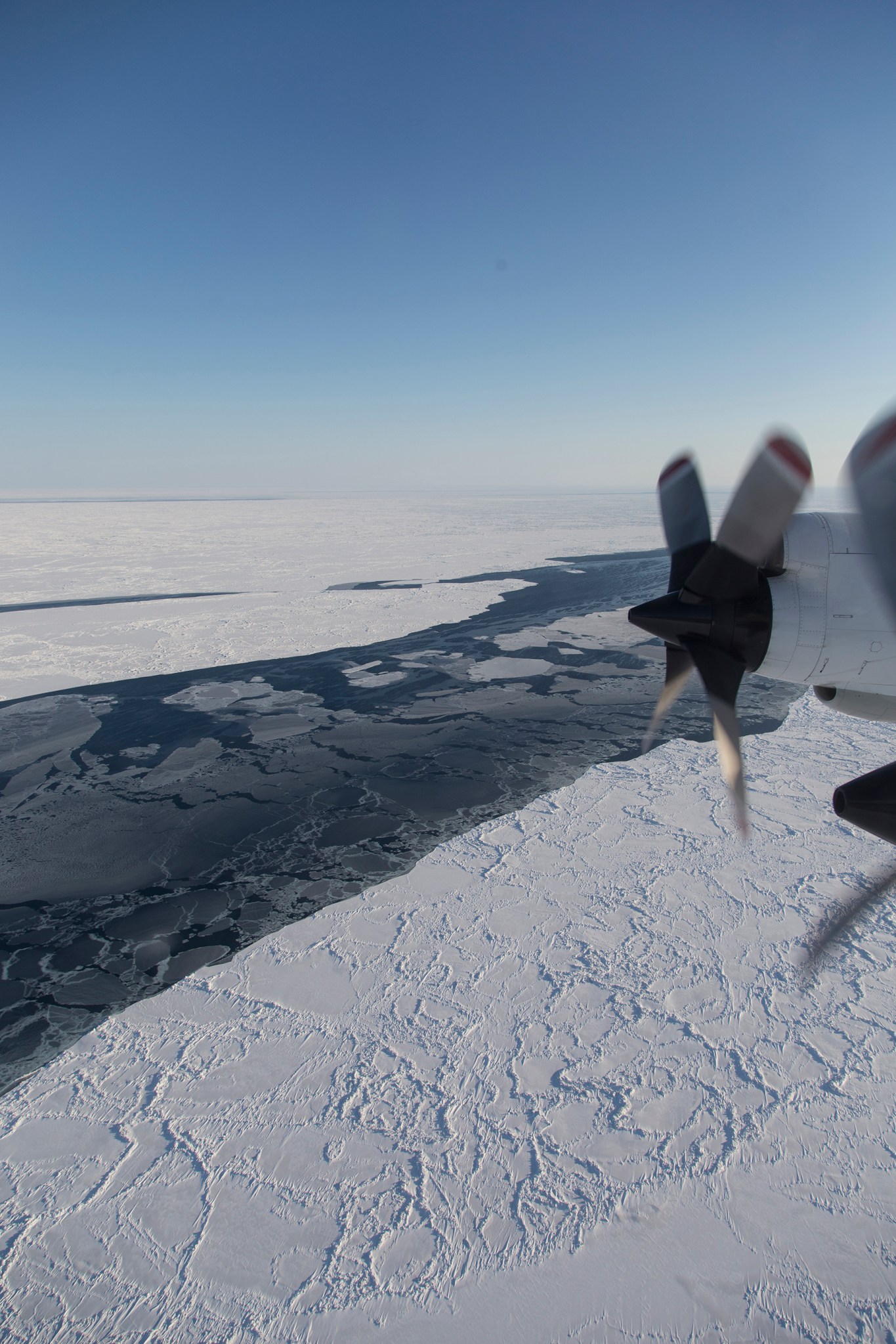 view from airplane of sea ice cover near Alaska