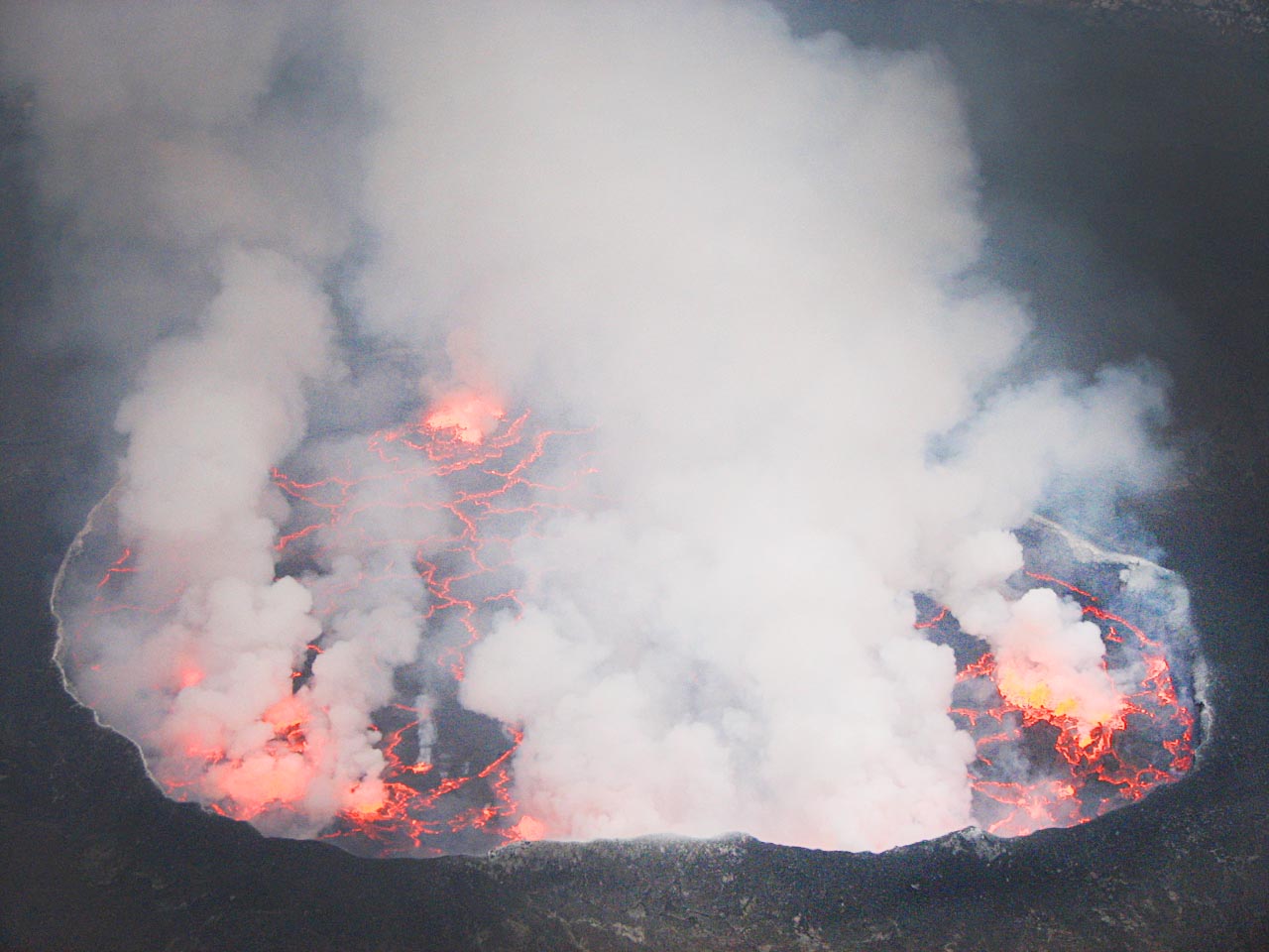 a smoking lake of lava viewed from above