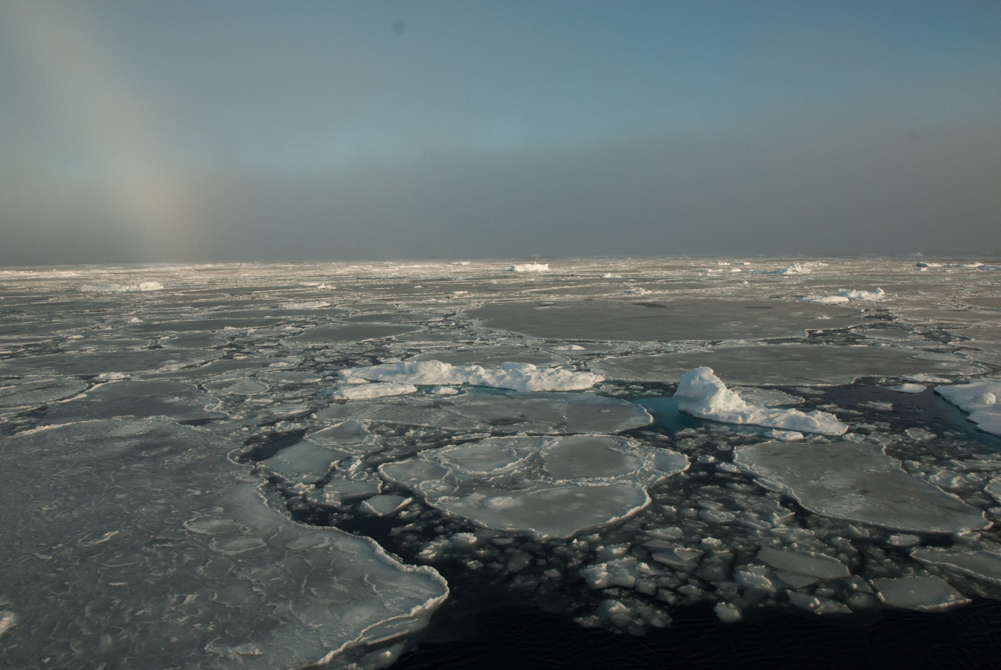 sea ice with sundogs near the horizon