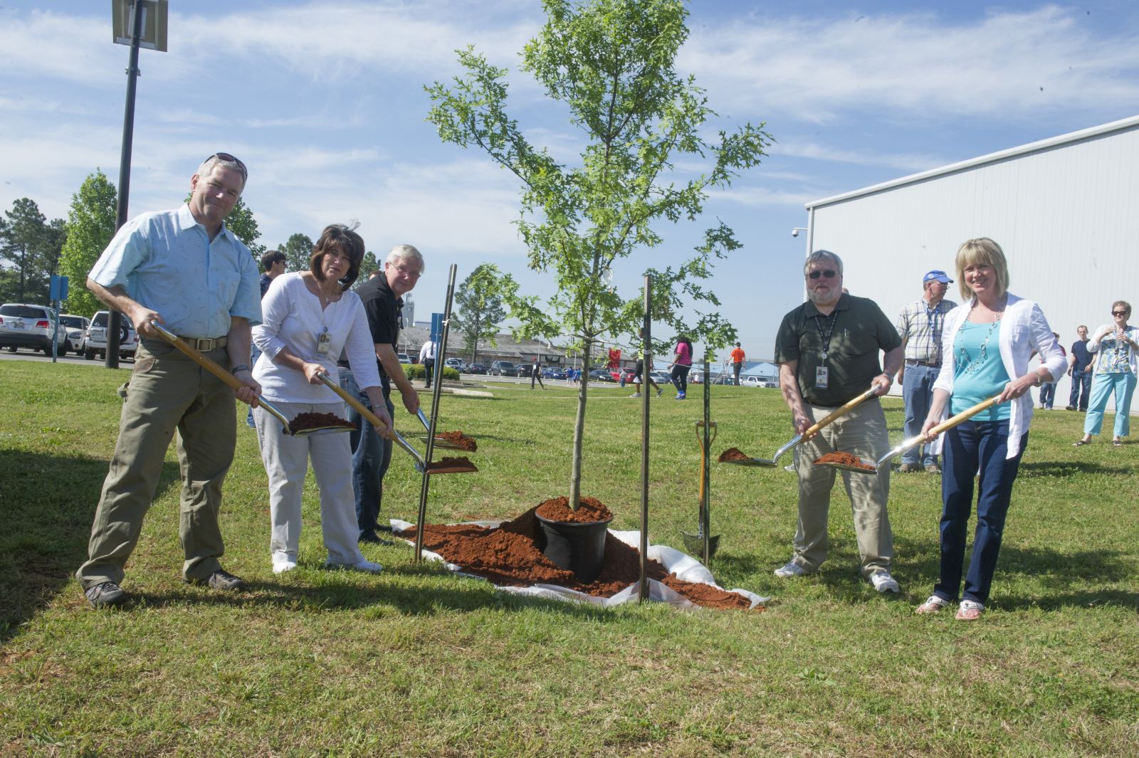 A tree is planted during SHE Day activities in 2014.