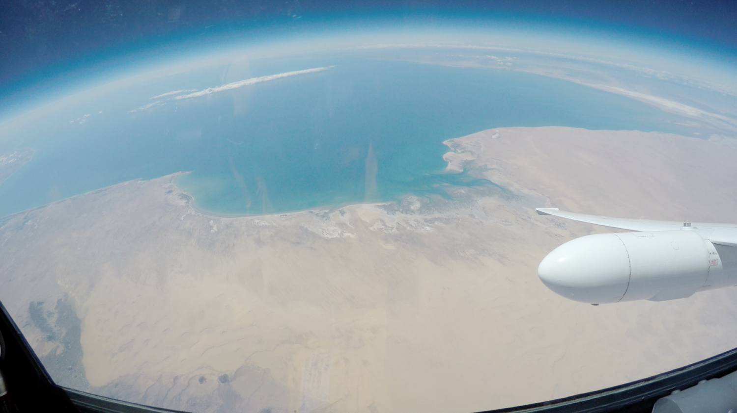 view from plane showing desert and part of a wing