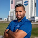 Kennedy Space Center's Marcos Peña is photographed in front of the Vehicle Assembly Building.