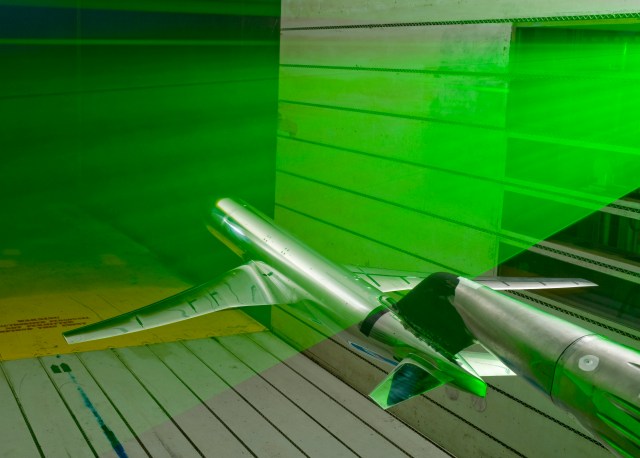 model of generic transport airplane in wind tunnel with green laser beam