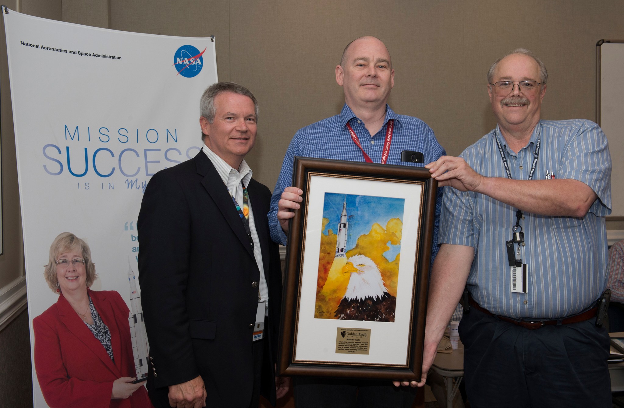 Robert Fought, center, receives the Golden Eagle award from Rick Burt, right, and Randy Lycans.
