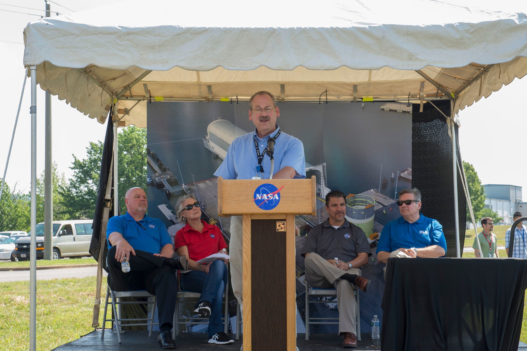 Robert Bobo discusses upcoming structural tests for the SLS core stage before team members tour the test facility May 19. 