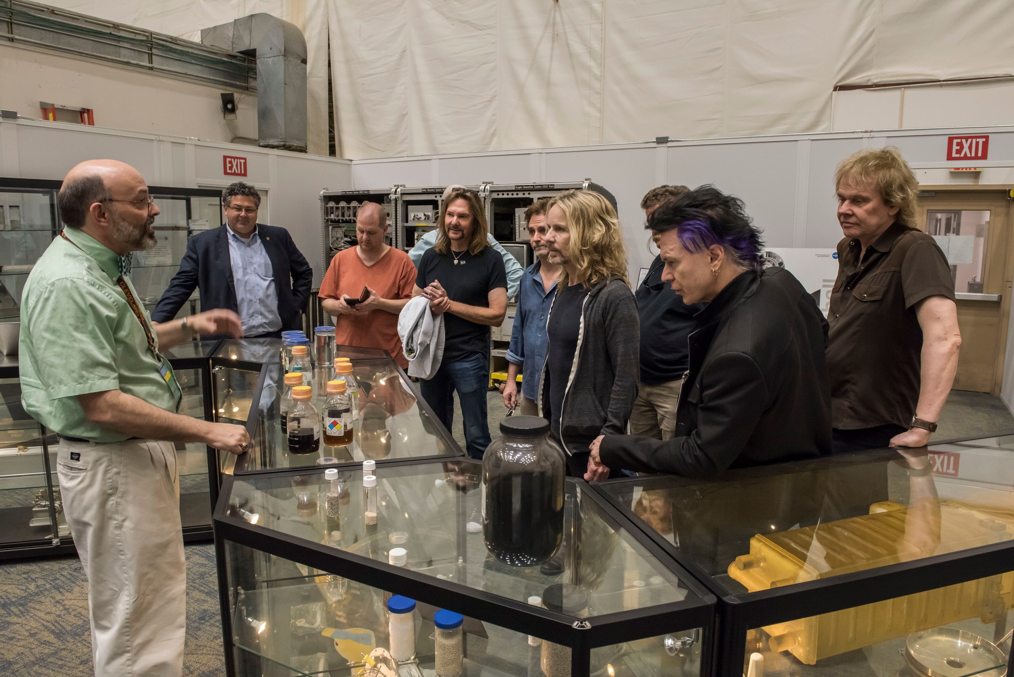 Keith Parrish discusses the process of the ECLSS with Todd May, second from left, and members of the legendary rock band Styx.