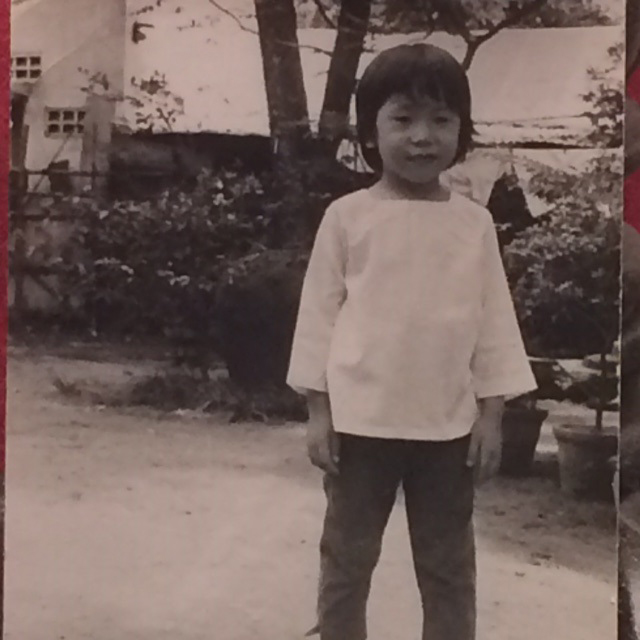 Photograph of 4-year-old Lien Moore, taken by a family member near their home in Saigon.