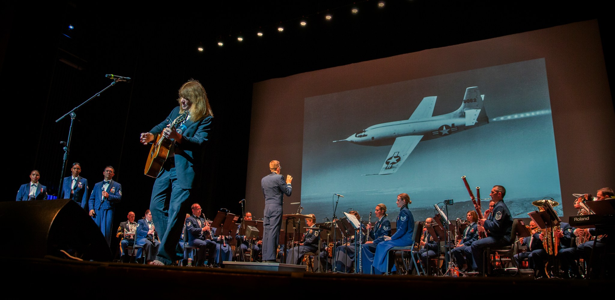 Musician Karl Werne, backed by the U.S. Air Force Heritage of America Concert Band, performs an original song.