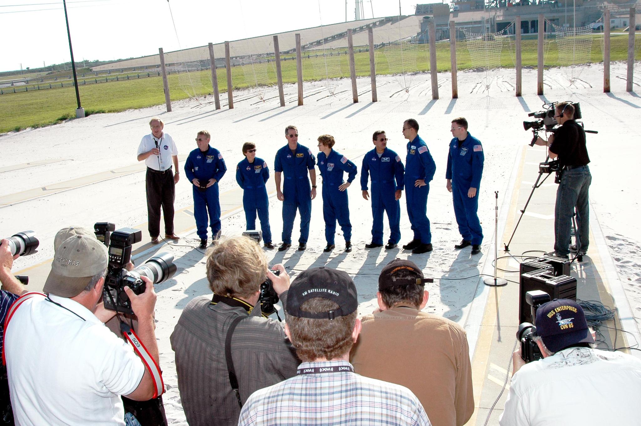 The STS-114 crew gathers for a media question-and-answer session moderated by George Diller, left.