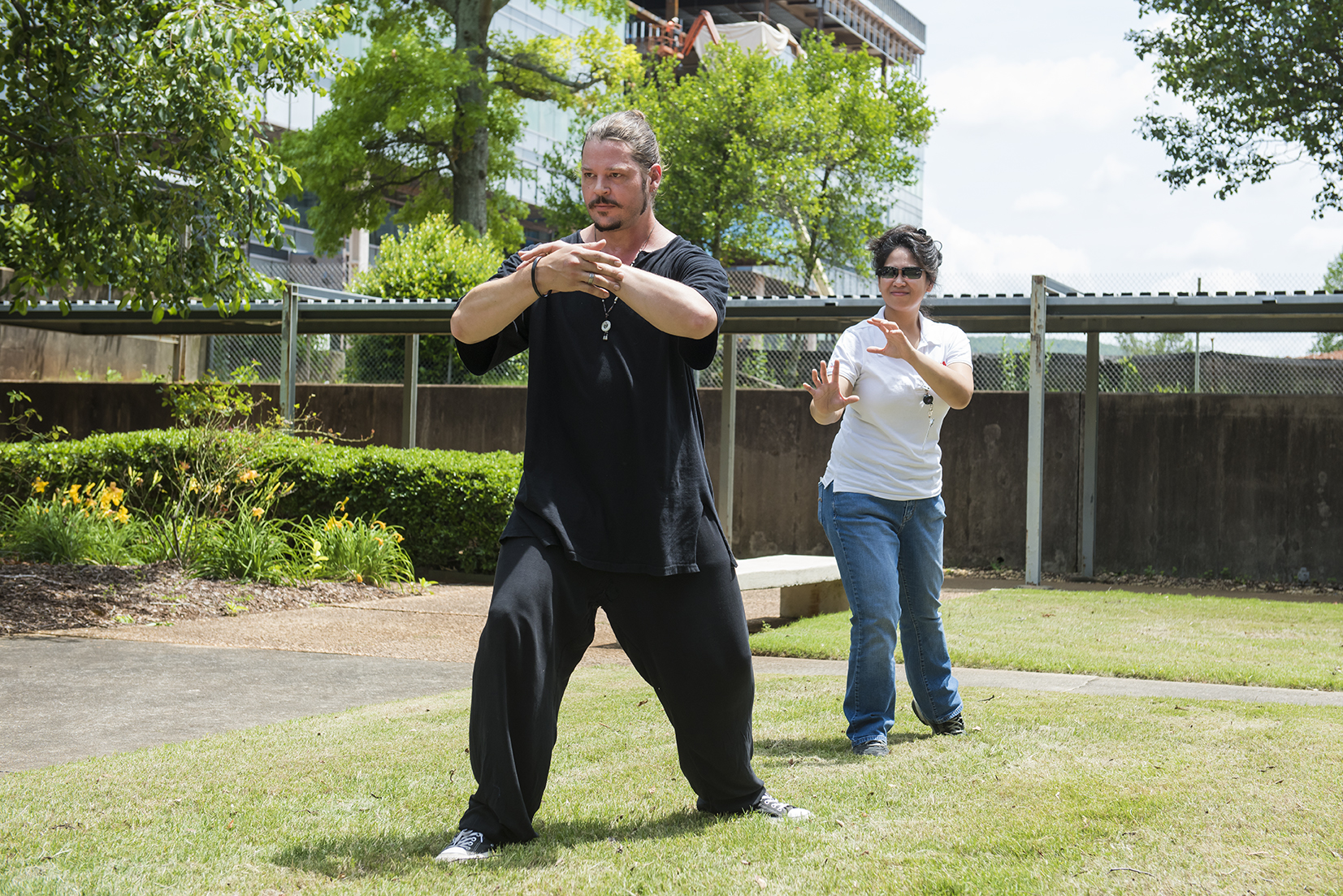 Warren Cain, an instructor at WuDang Martial Arts Center in Huntsville, leads Marshall Pathways intern Donna Cendana