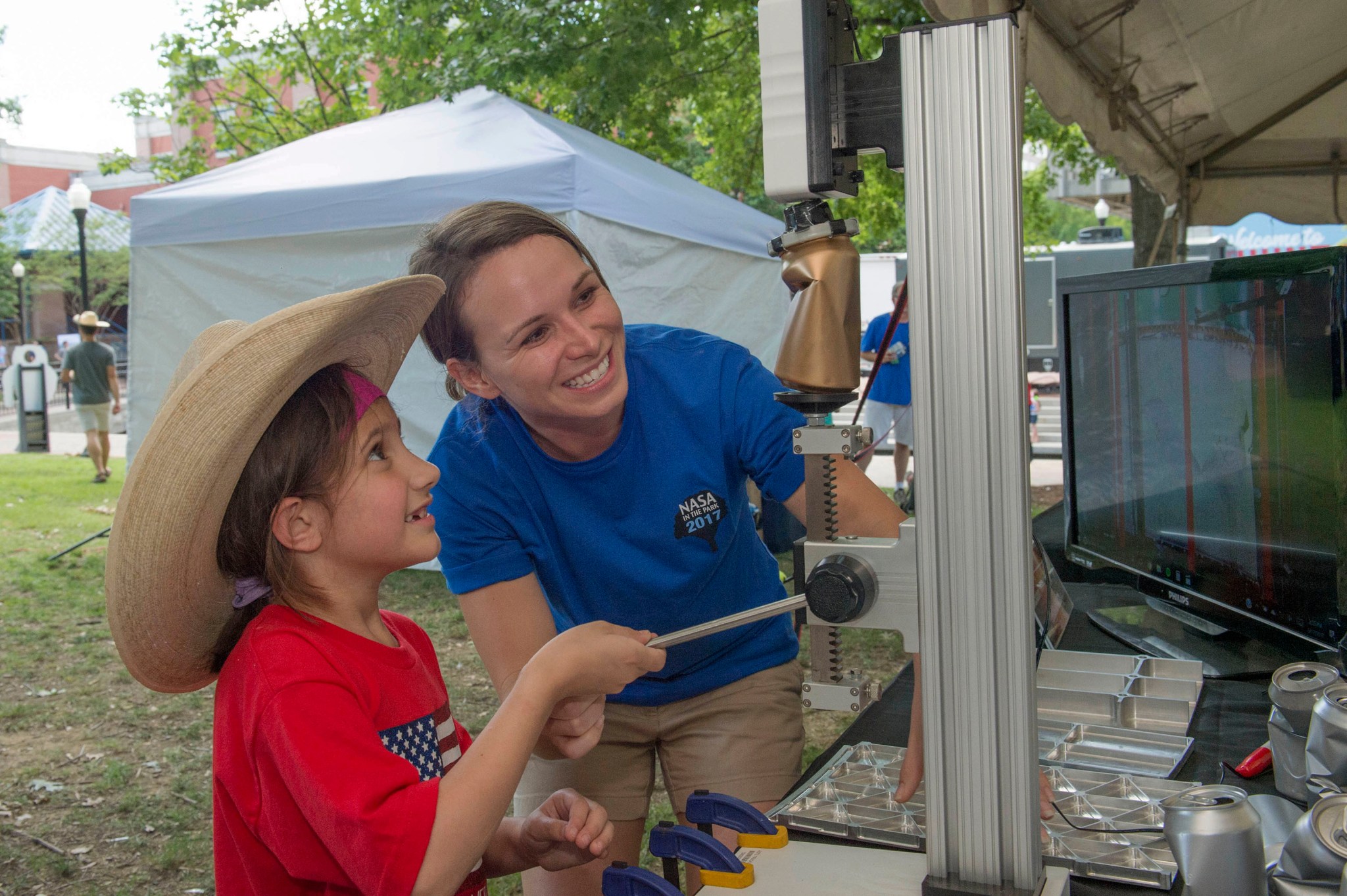 Michelle Tillotson Rudd uses soda cans to demonstrate structural loads testing of rocket hardware performed at Marshall. 