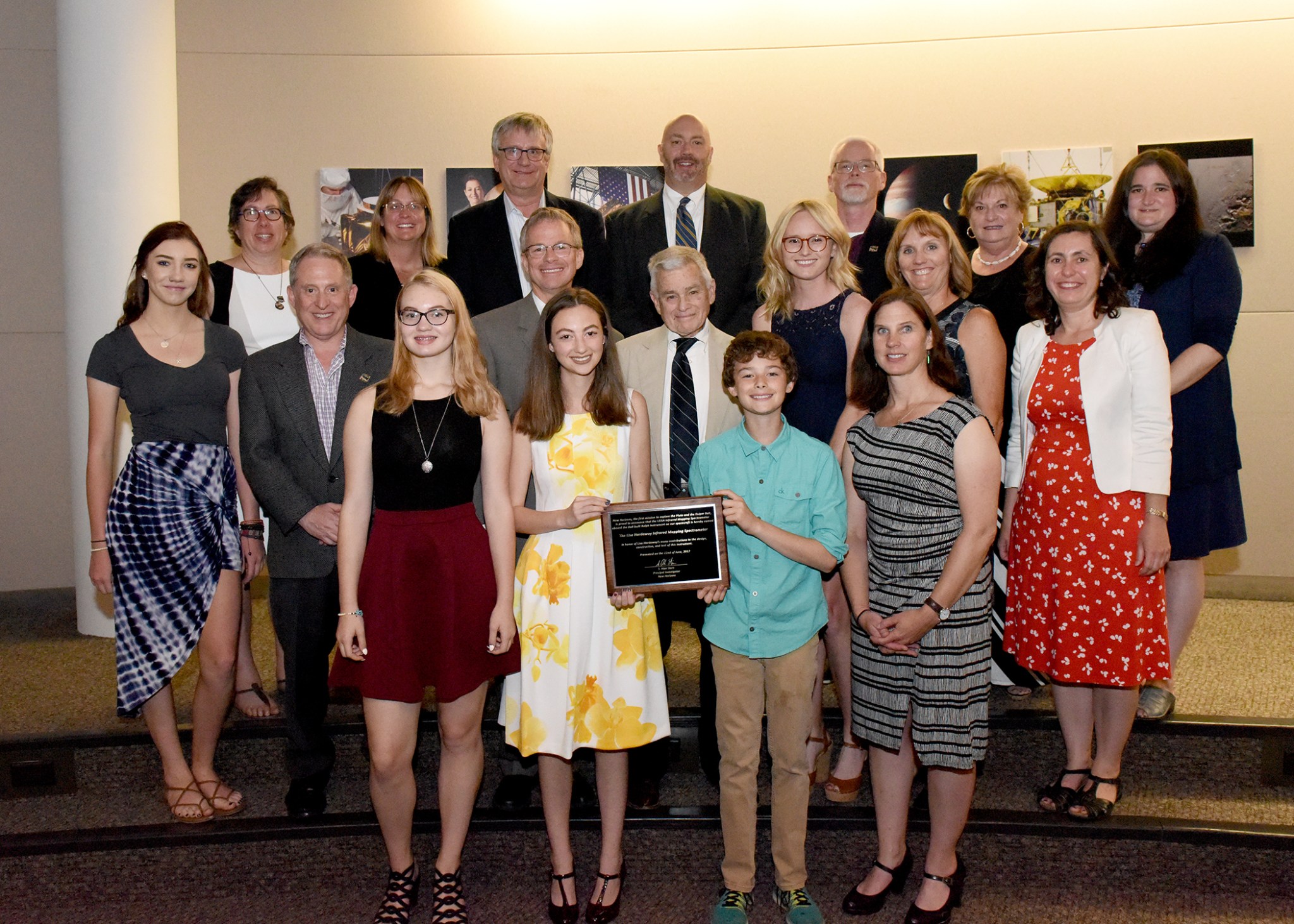 Friends and family of Lisa Hardaway accept a plaque in honor of her life and contributions.