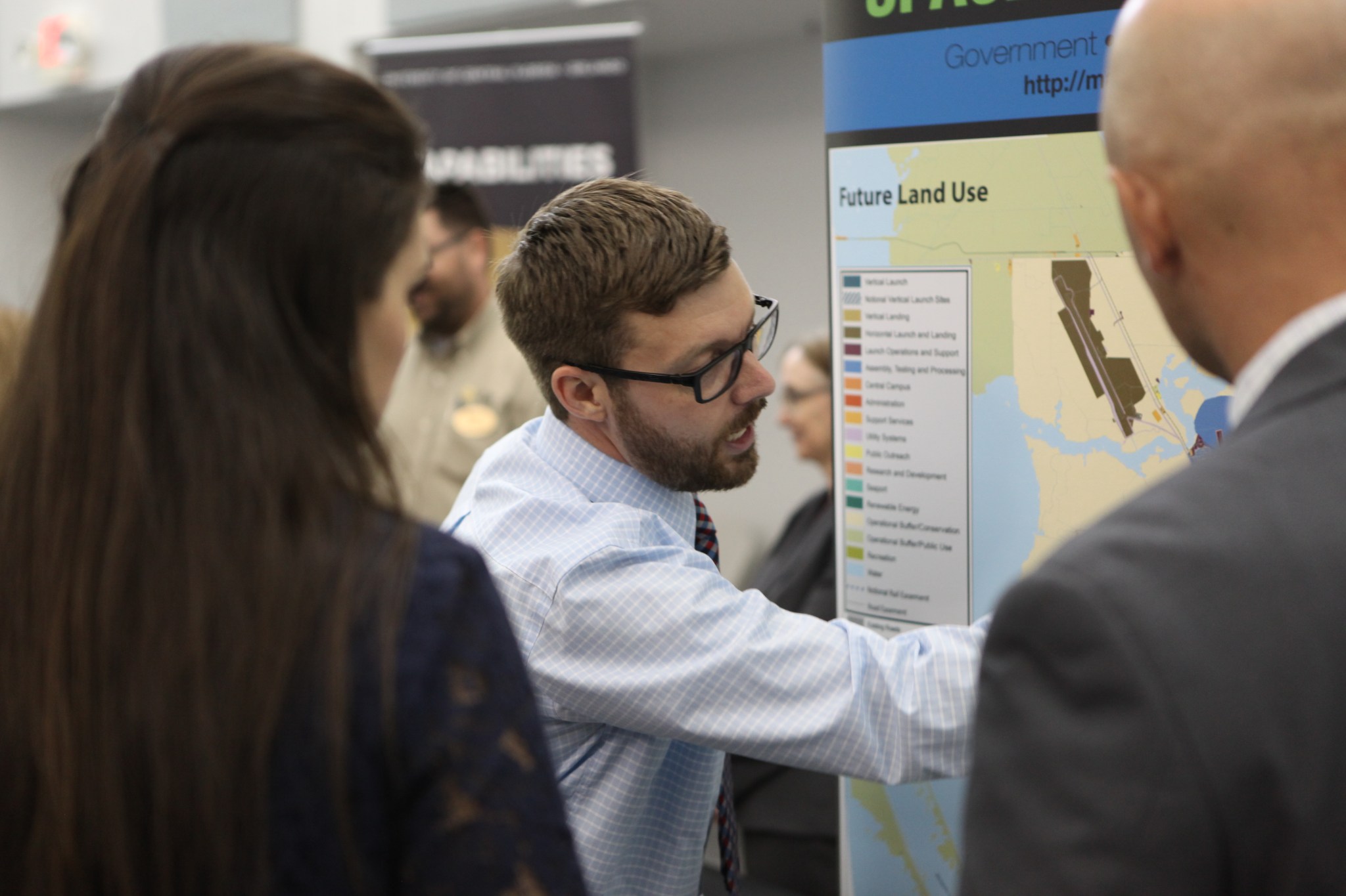 A presenter details the Kennedy Space Center plan for an audience.