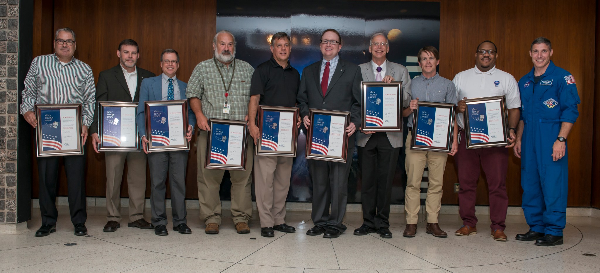 NASA astronaut Mike Hopkins, far right, gathers with Silver Snoopy honorees after the award ceremony June 15.