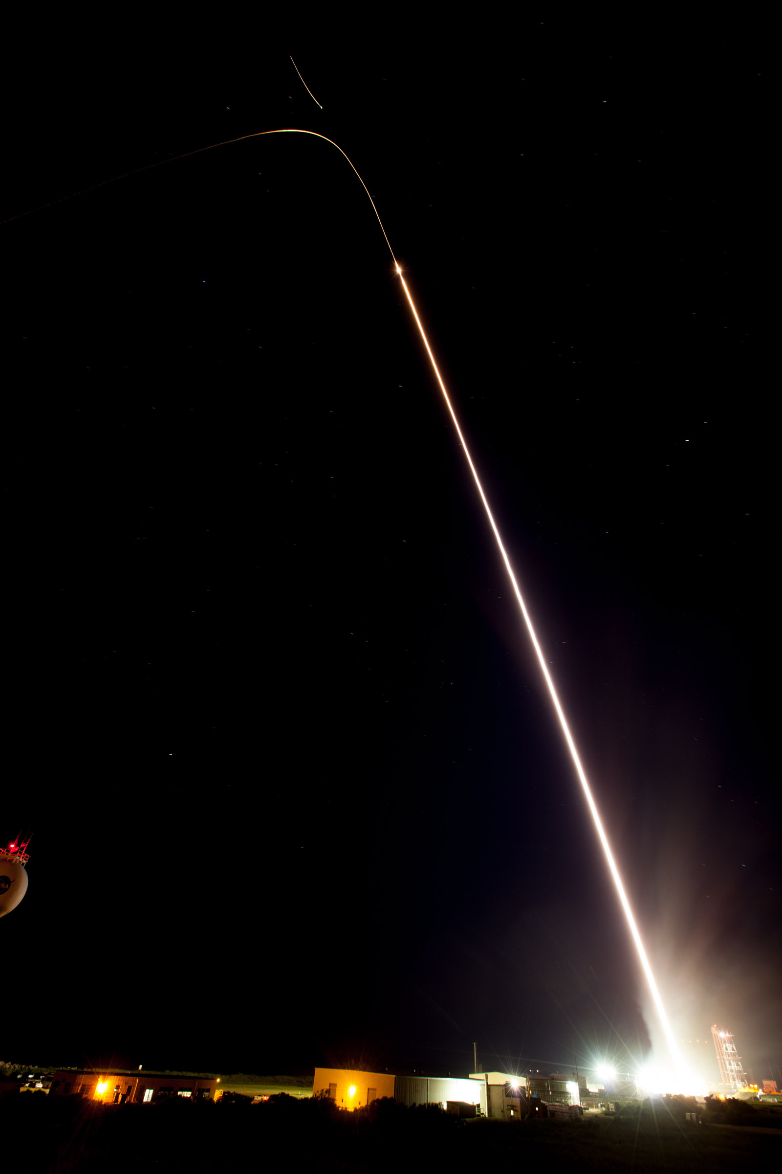 A long exposure image of a sounding rocket launching, represented by a white streak.