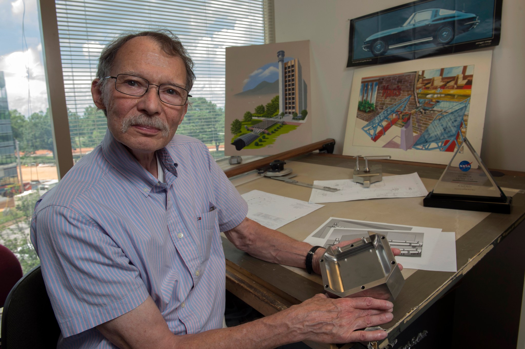 Neill Myers, Marshall’s most patented inventor, demonstrates the Variable-Aperture Reciprocating Reed Valve.