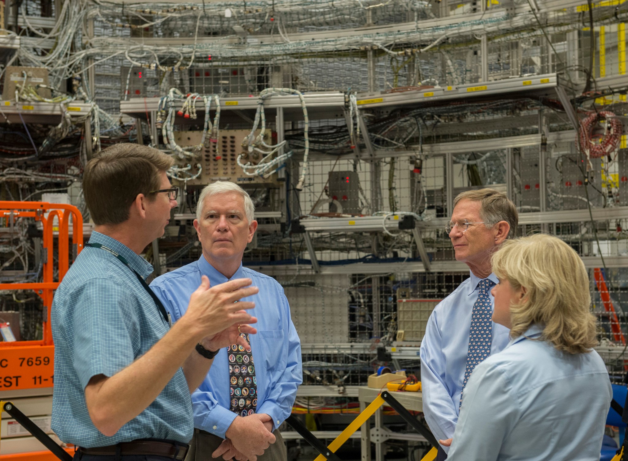U.S. Rep. Mo Brooks, second from left, and U.S. Rep. Lamar Smith, second from right, view progress on NASA's Space Launch System