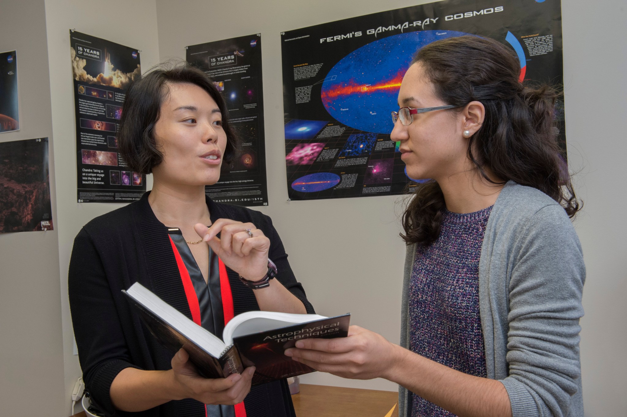 : Michelle Hui, left, an astrophysicist confers with Rachel Hamburg, a space science gra