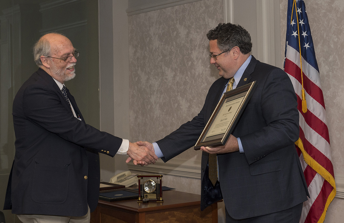Robert Wilson, left, receives the Career Service Recognition Award from Marshall Center Director Todd May.