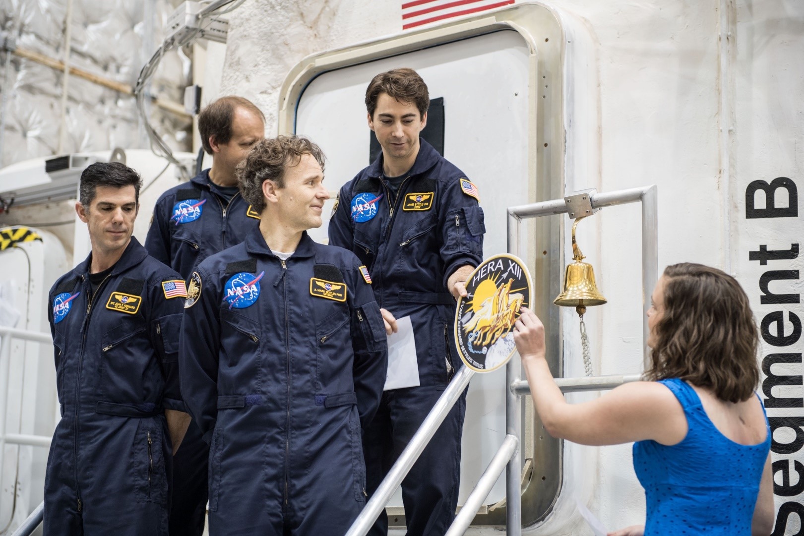 Moments after turning the vessel back over to NASA after 45-days inside, the HERA XIII crew is given their mission patch to plac