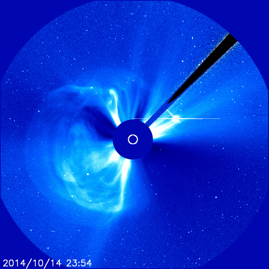 A coronograph in blue, with a darker blue circle in the middle. In the very middle of this circle is the Sun. The darker blue circle is surrounded by lighter swirls of blue, indicating space weather activity.