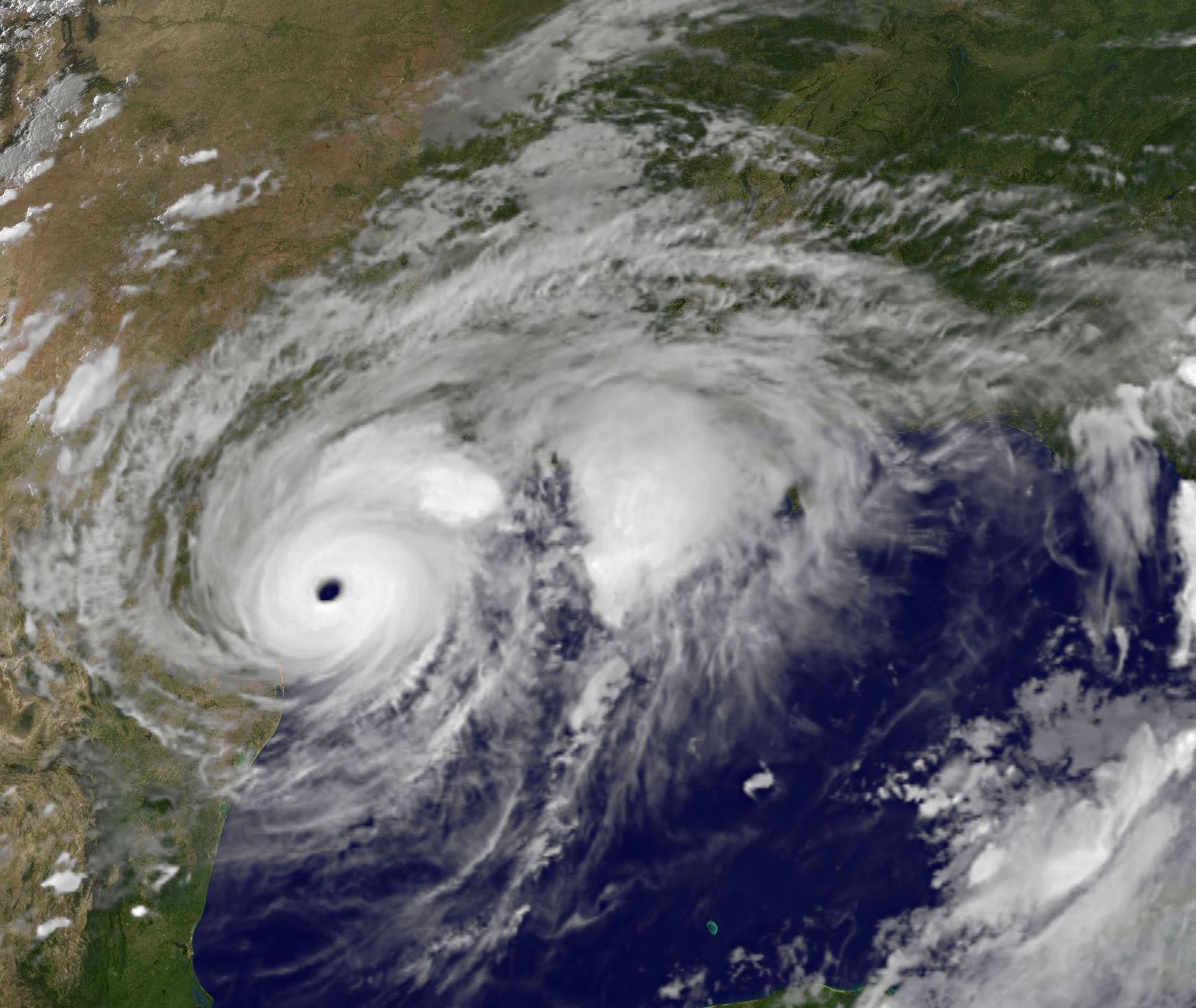 Satellite image of Harvey, a spiral cloud mass with a clear eye over the eastern coast of Texas.