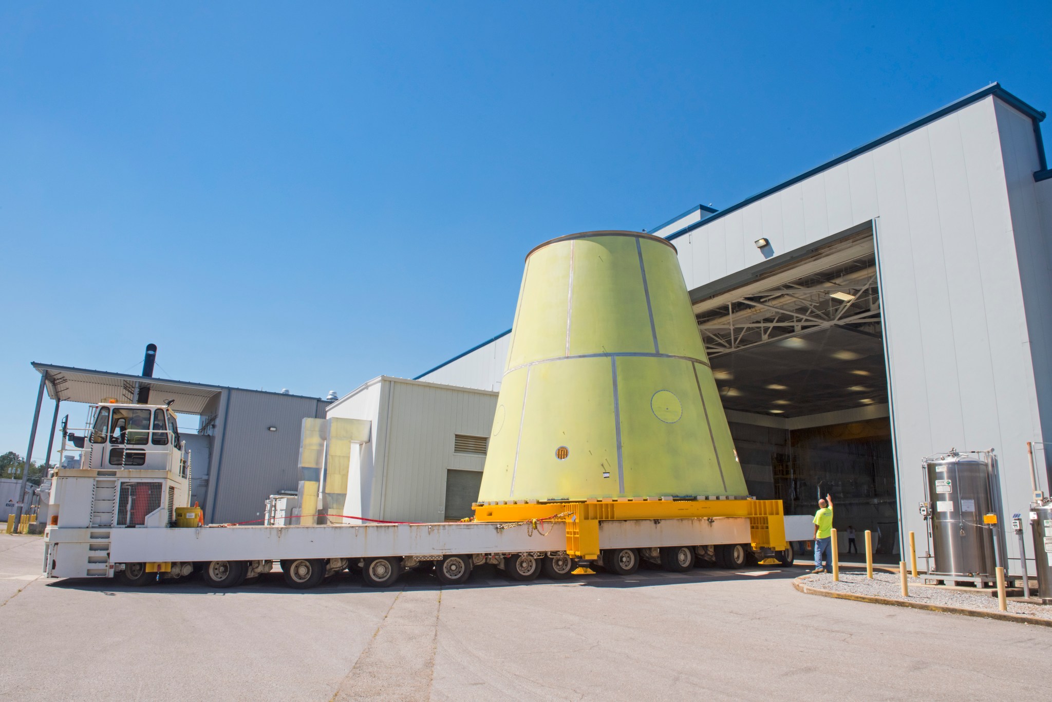 A NASA K-mag transporter tractor with 96 wheels hauls the Space Launch System’s launch vehicle stage adapter (LVSA).