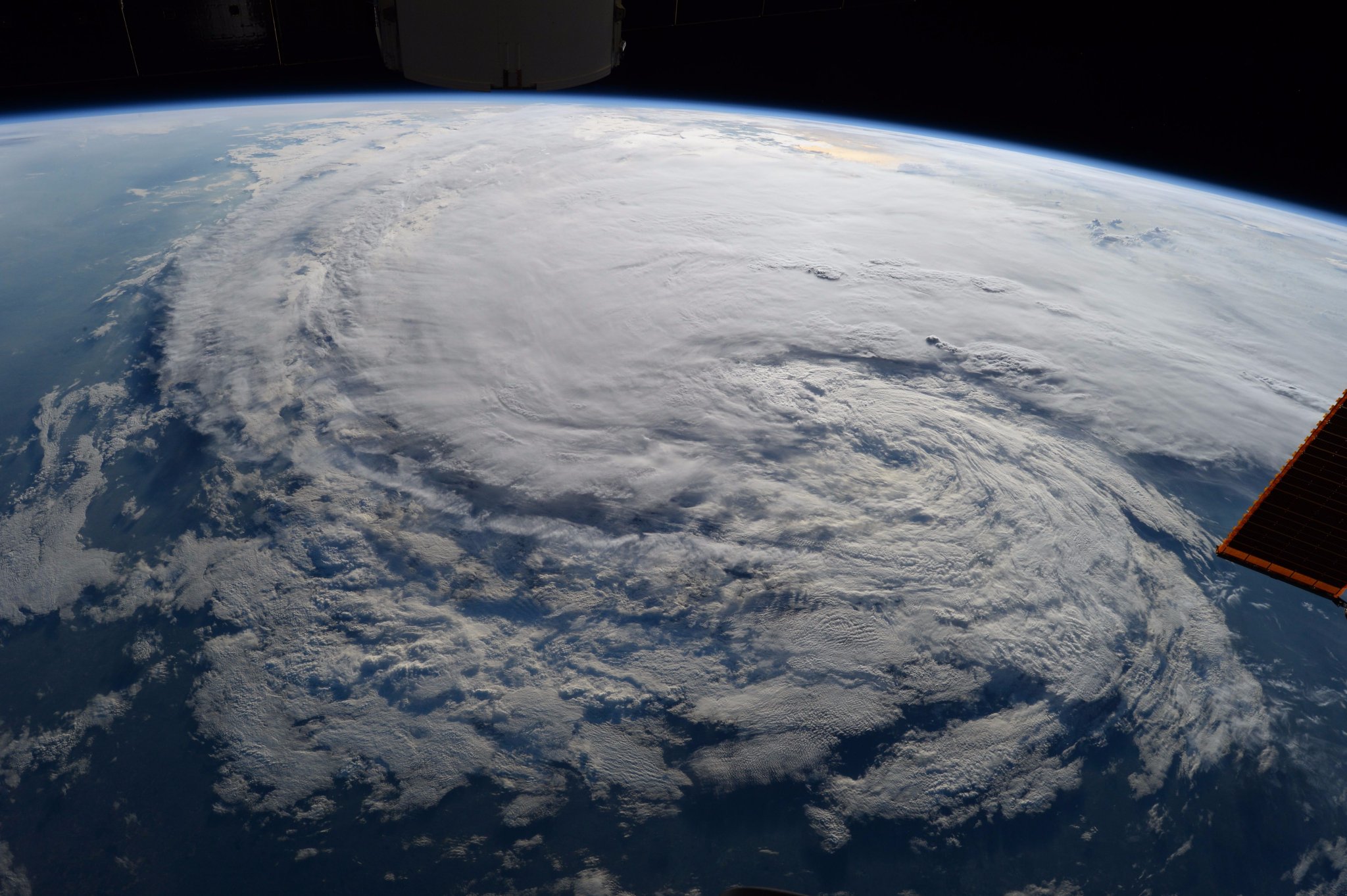 Harvey seen from the ISS, a huge swirling cloud mass seen from an oblique angle.