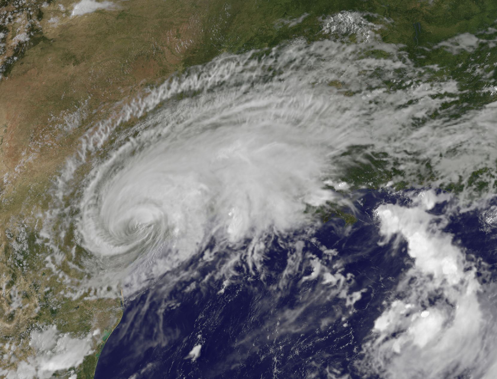 Satellite image of Harvey, a comma shaped swirling cloud mass over the eastern Texas coast.