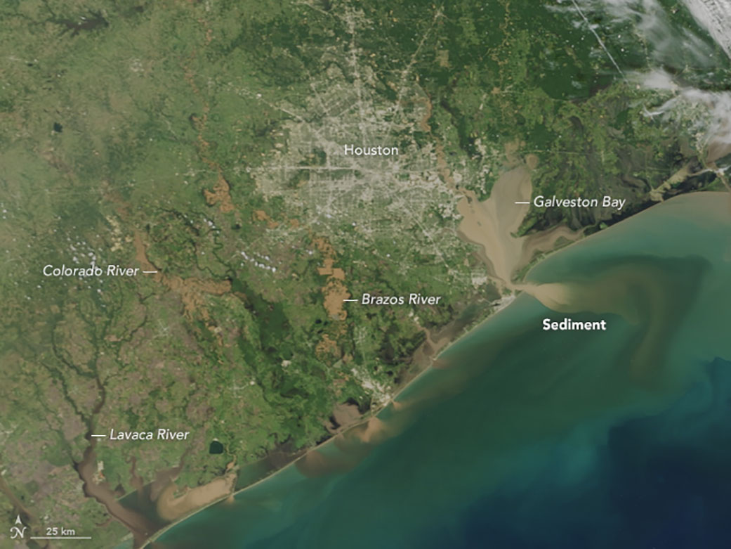 Satellite image of the area right around Houston, Texas. Galveston Bay is beige with flooded sediment, which is also running into the ocean.