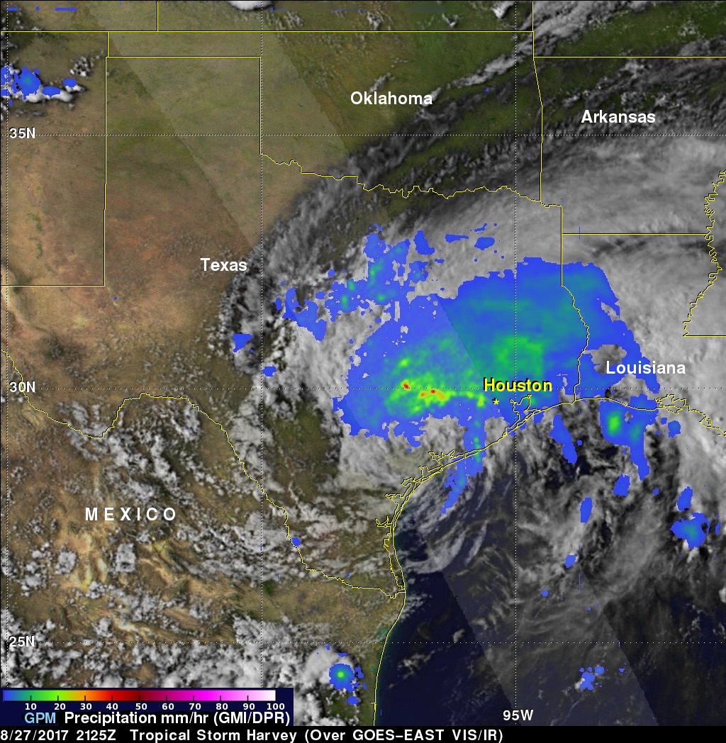 Satellite image of Harvey with rainfall totals in greens and blues.