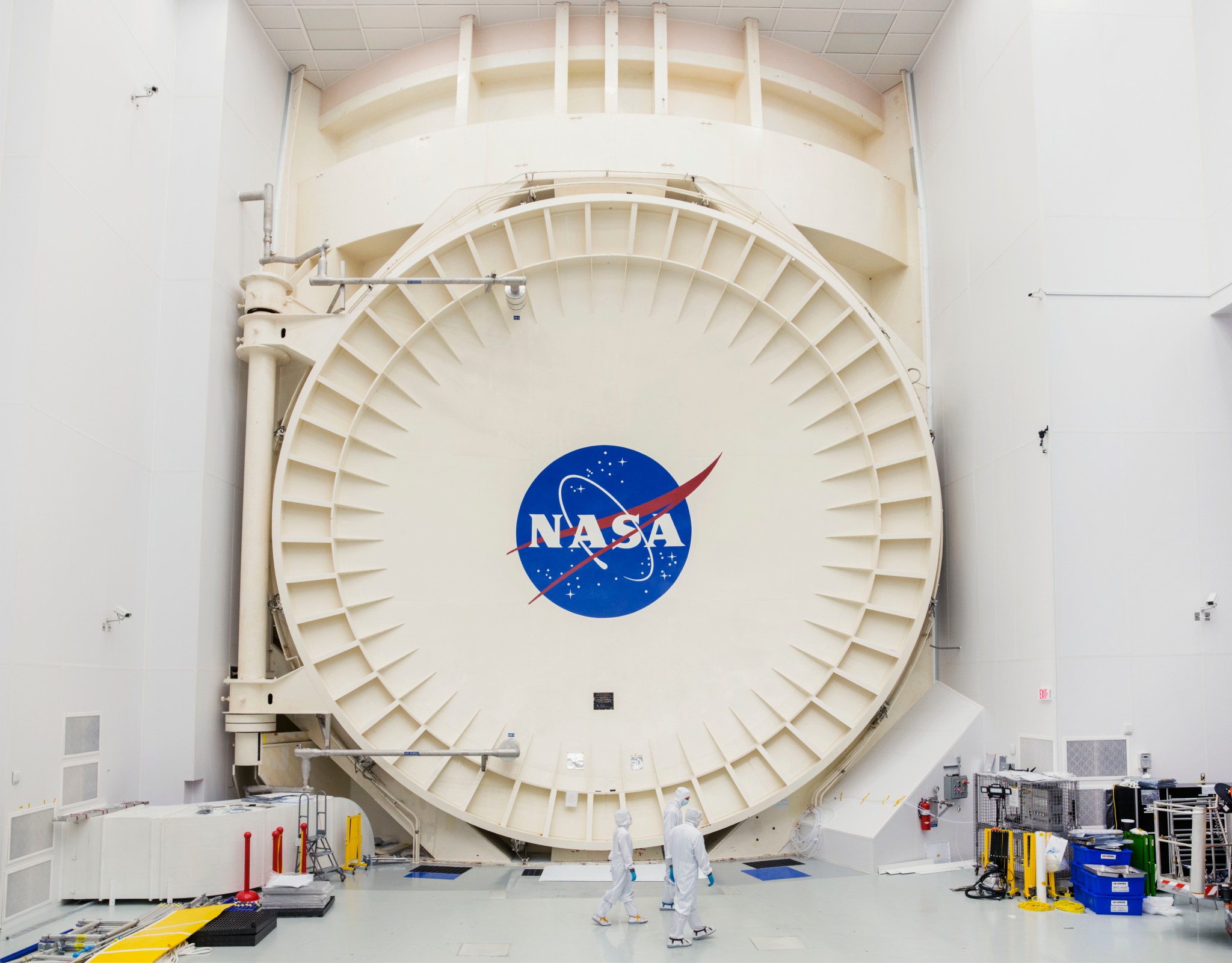 Chamber A’s sealed, vault-like door towers over engineers at NASA’s Johnson Space Center in Houston.