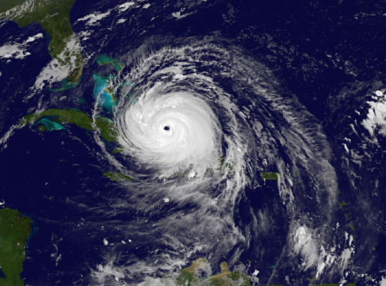 Satellite image of Irma, a classic spiral mass of clouds with a central eye over the Atlantic Ocean.