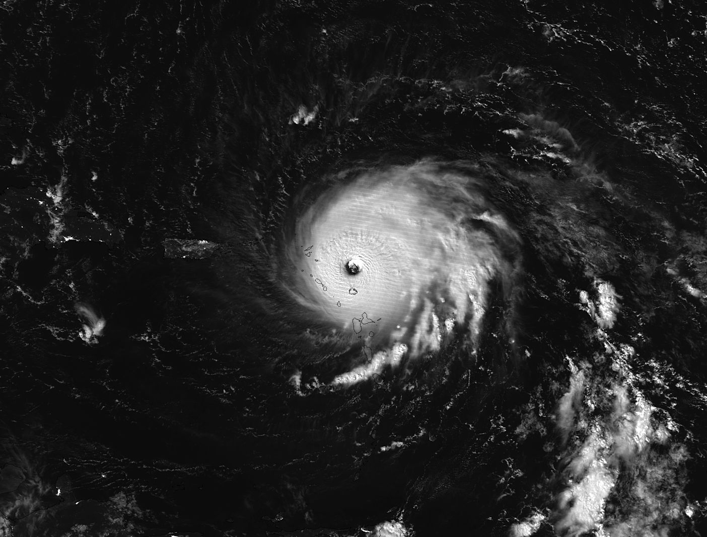 Black and white nighttime image of Irma, with the swirling white cloud mass very visible against the dark ocean.