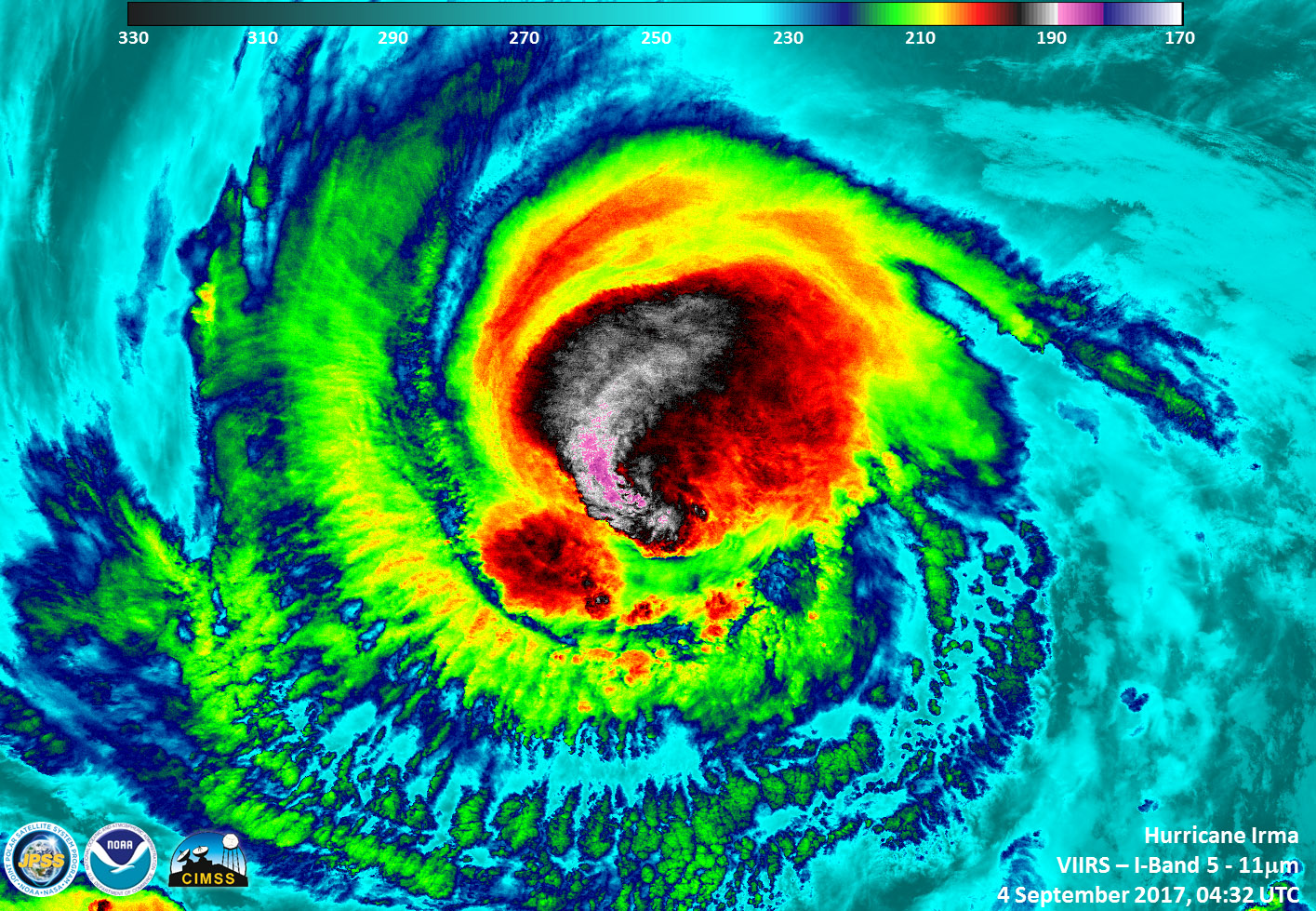 Satellite image of Irma, with clouds colored red, yellow, black, and blue.