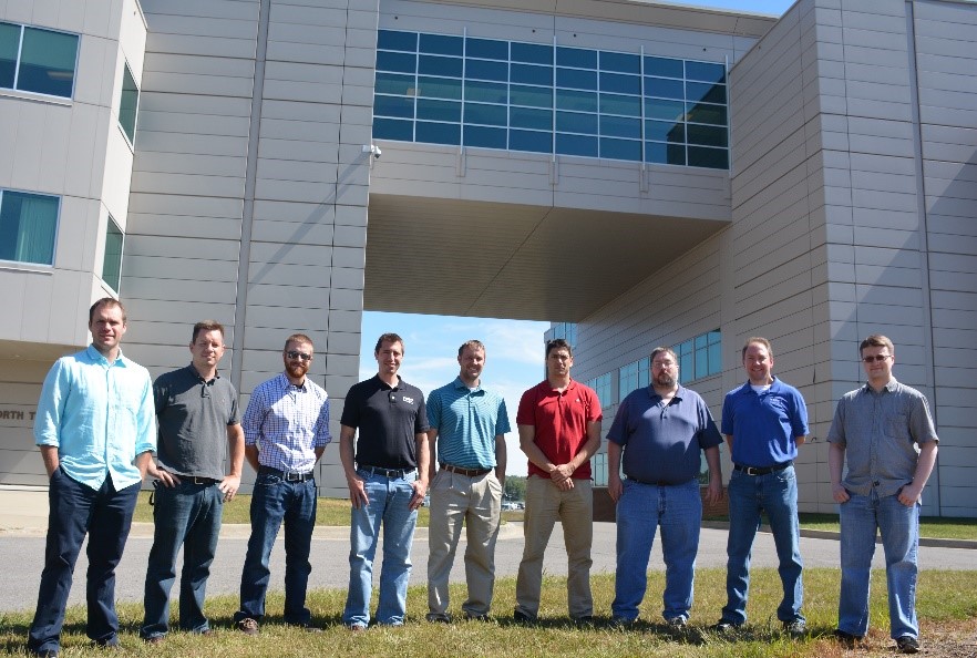 JSTAR JIST Team standing in front of a building