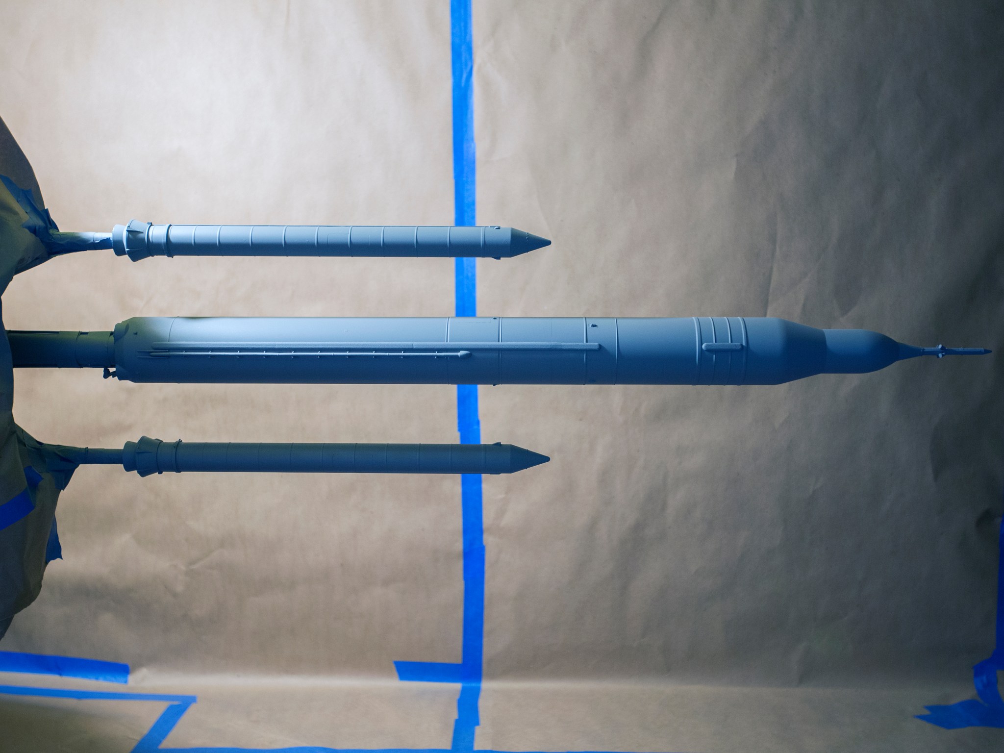 A scaled model of the Space Launch System outfitted with its pressure-sensitive paint.