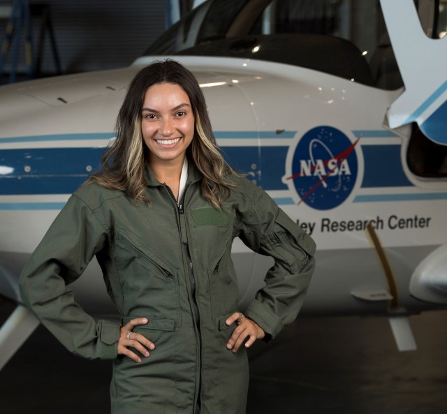 A woman standing in front of a NASA Research Center airplane