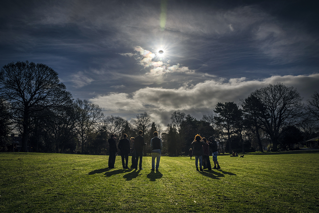 people watching a partial eclipse