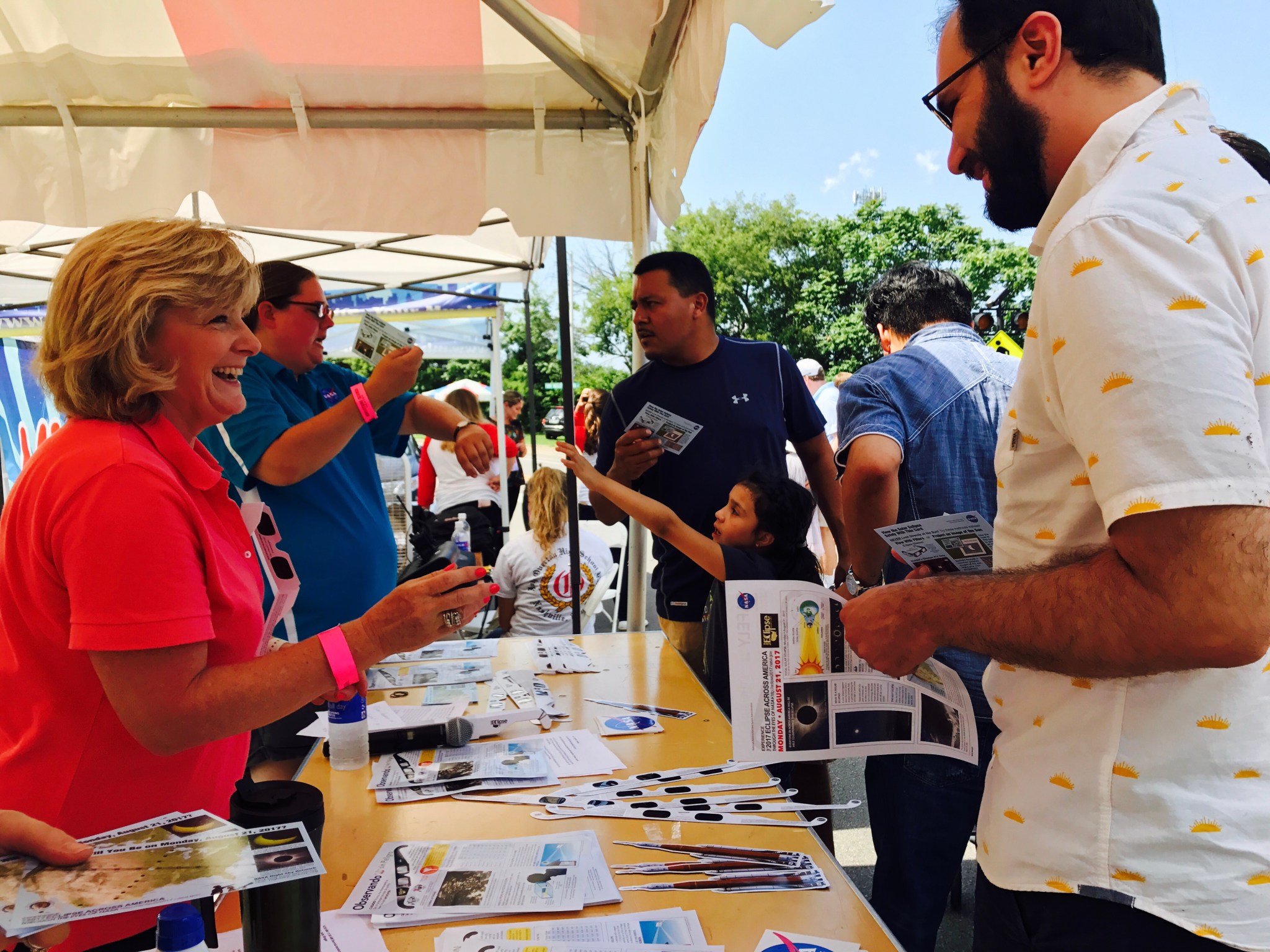Marshall Deputy Director Jody Singer, left, greets visitors under a tent at the Adventure Science Center.