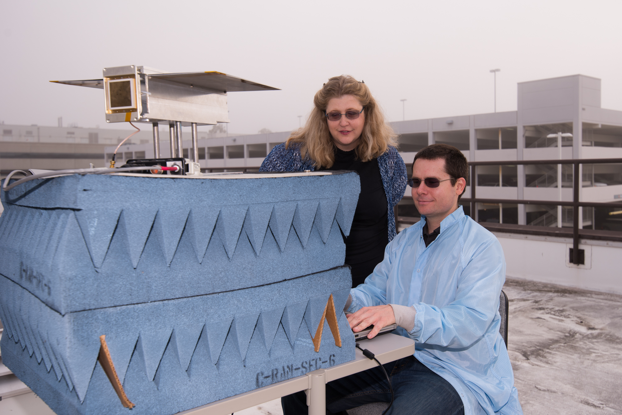 Research scientist Dr. Rebecca Bishop, left, and design engineer Steve Bielat of The Aerospace Corporation