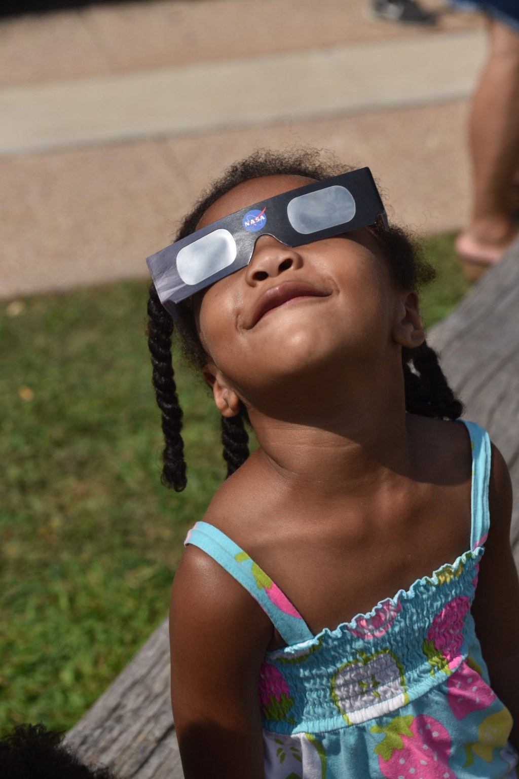 A young eclipse viewer experiences the Aug. 21, 2017 total solar eclipse in Cleveland, Ohio using protective glasses