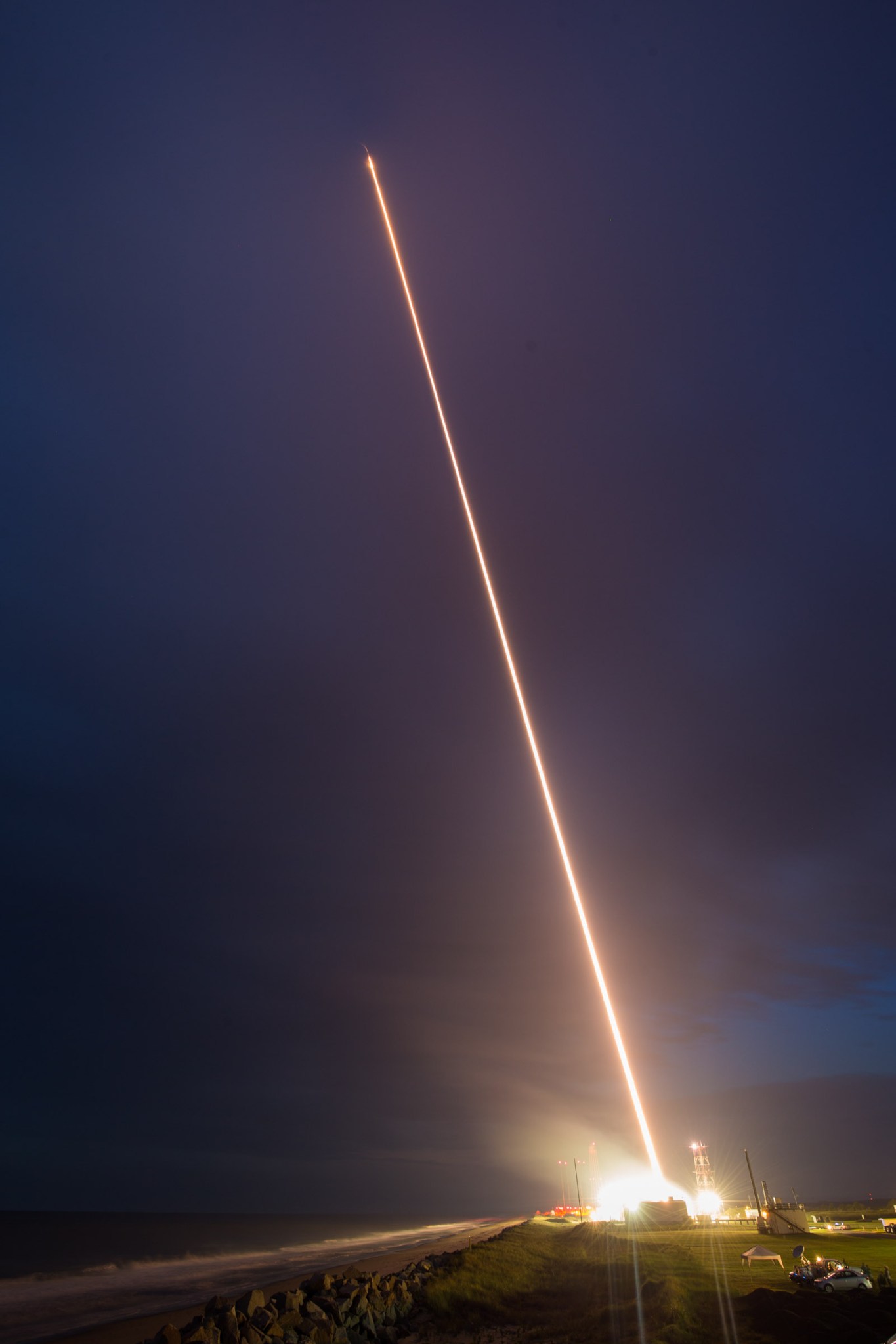 A long exposure photograph of a sounding rocket launch. A long, white streak represents the sounding rocket launching.