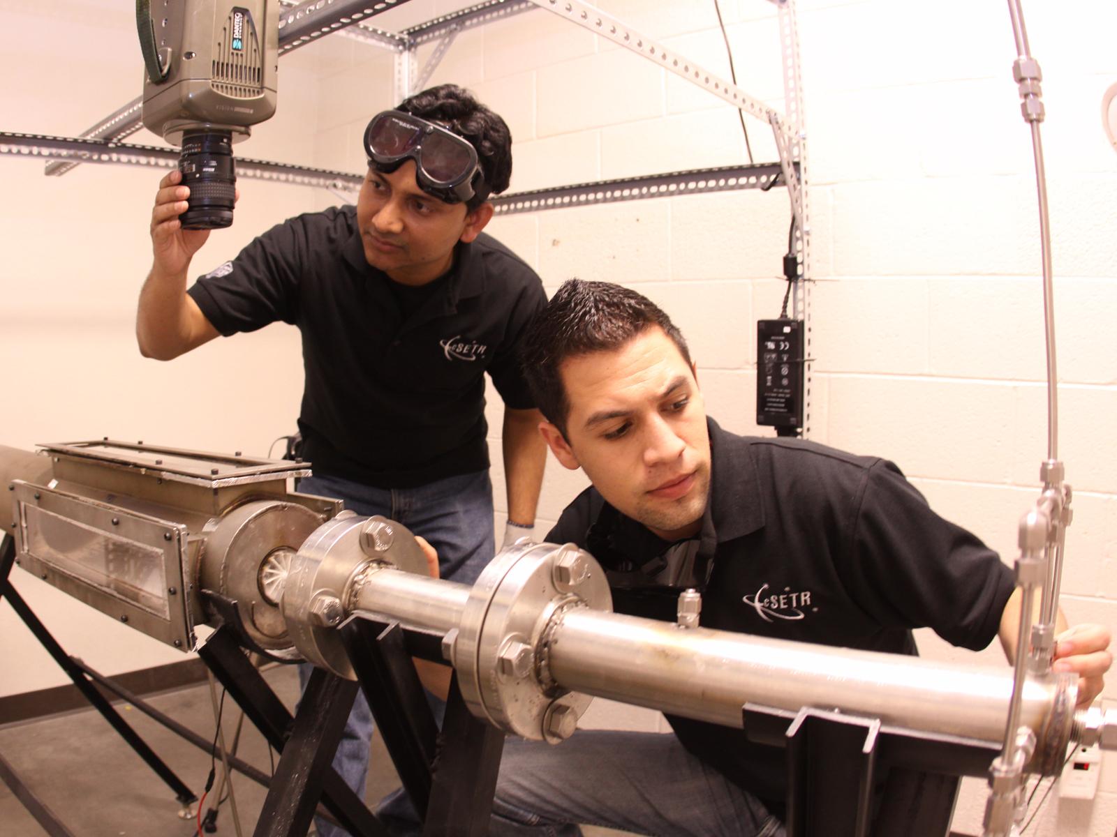 Research assistants in the Center for Space Exploration Technology Research setup a laboratory scale turbine combustion rig