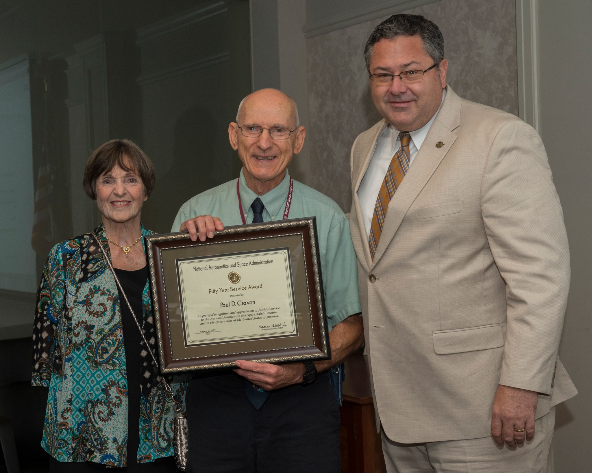 Receiving his 50 Year Service Award Aug. 14, Paul Craven, center, with his wife, Kathy Craven and Marshall Center Director Todd 