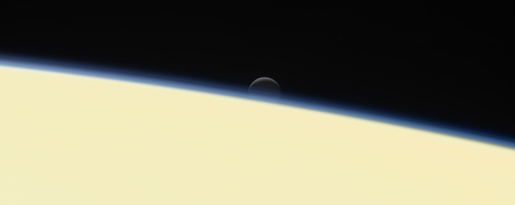 Saturn's Moon Enceladus Setting Behind the Planet