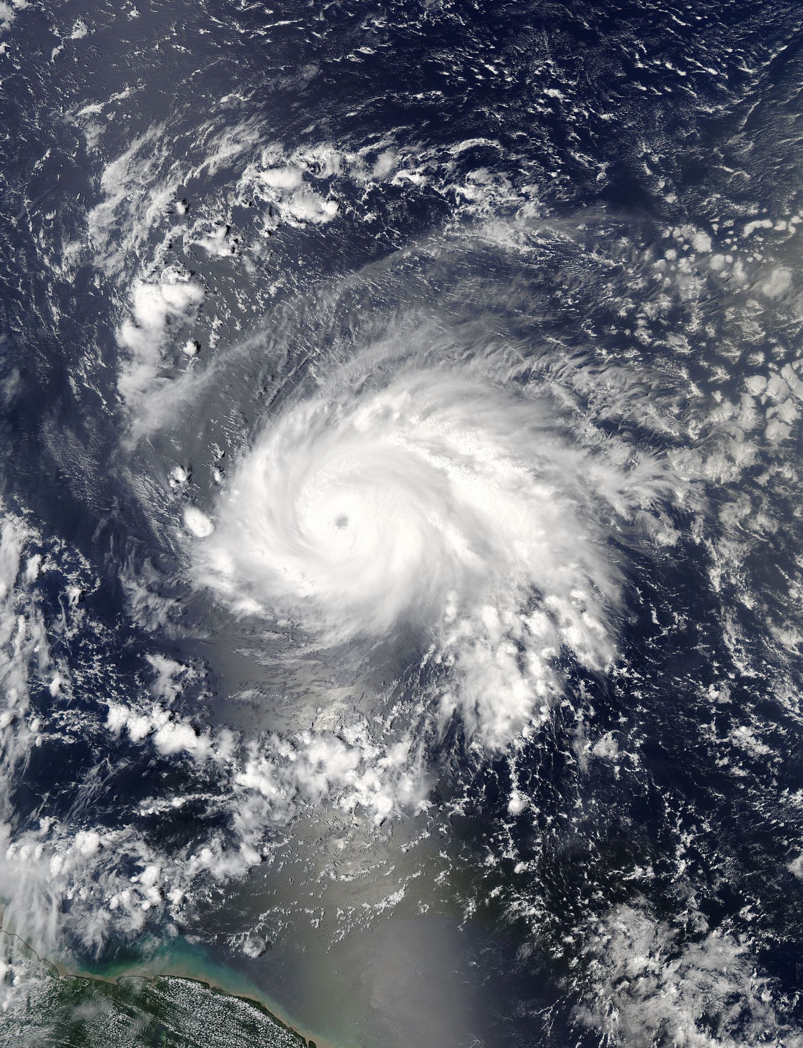 Satellite image of Jose, a swirling cloud mass with a clear eye, over the ocean.