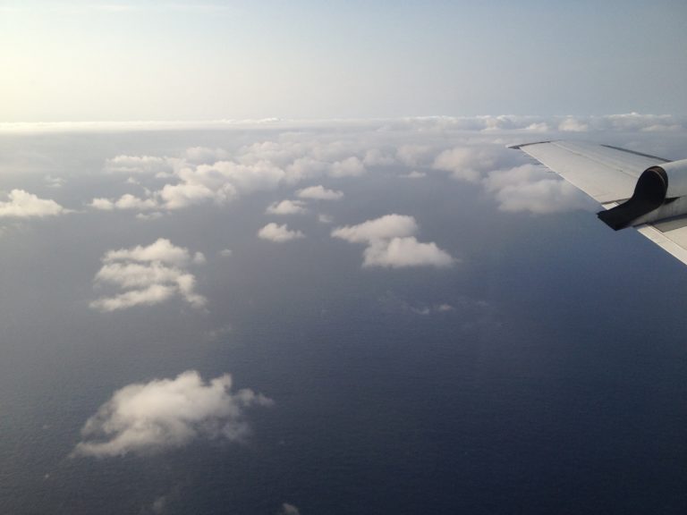 Visible haze layer above and around some small cumulus clouds, as seen from the window of NASA’s Orion P-3 aircraft.