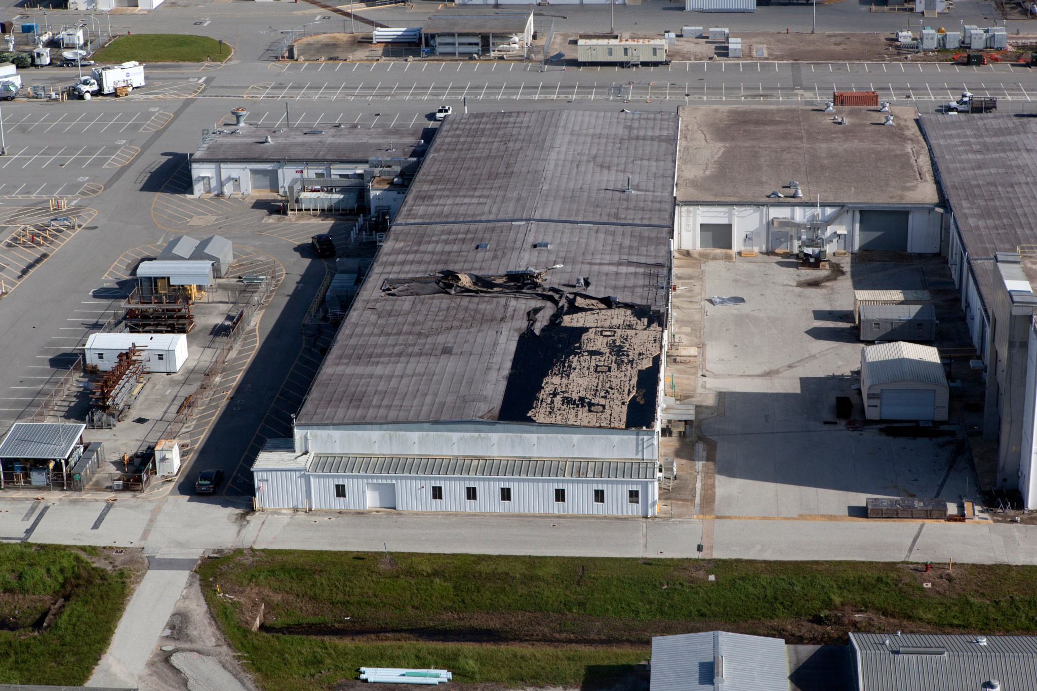 An industrial building behind the Space Station Processing Facility shows some roof damage following Hurricane Irma. 