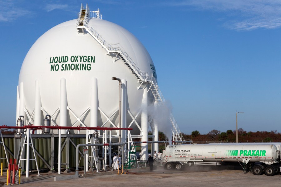 Praxair trucks offload liquid oxygen into a giant storage tank at Launch Pad 39B at Kennedy Space Center in Florida.